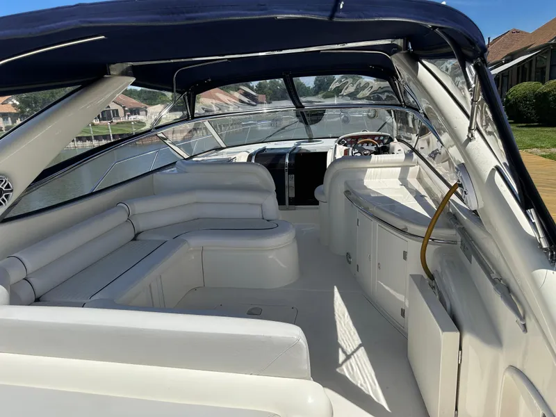 Slide: The Image of 1997 Sunseeker Camargue 47 yacht interior with white seating and blue canopy. - 29