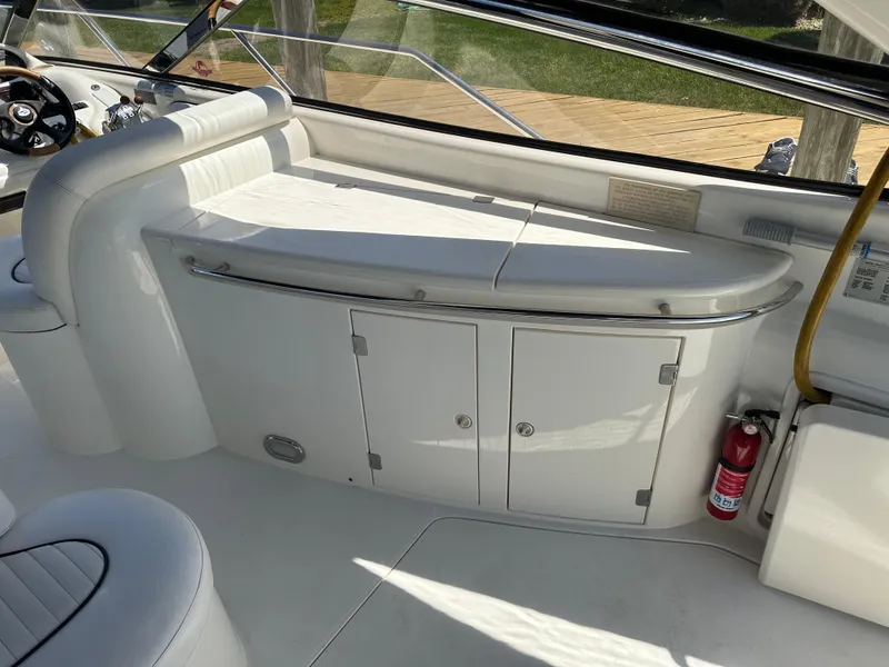 Slide: The Image of Interior of 1997 Sunseeker Camargue 47 yacht with white seating and storage cabinets. - 30