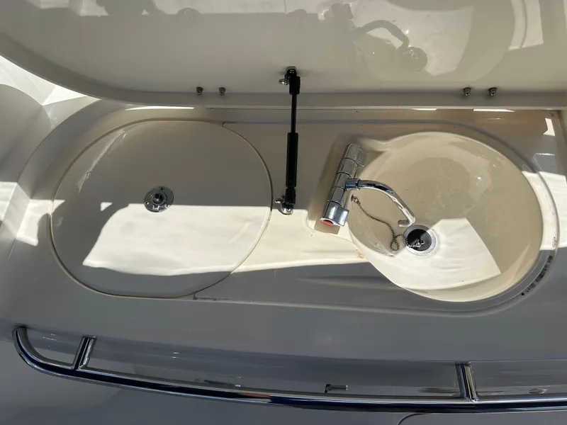 Slide: The Image of Sunseeker Camargue 47 yacht sink area, 1997 model, featuring dual basins and chrome faucet. - 32