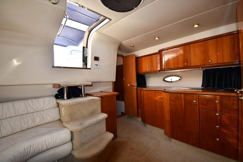 Slide: The Image of Interior of 1997 Sunseeker Camargue 47 yacht with wooden cabinets and white seating. - 39