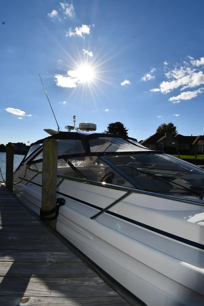 Slide: The Image of 1997 Sunseeker Camargue 47 yacht docked under a bright sunlit sky. - 4