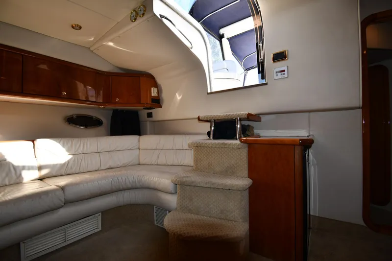 Slide: The Image of Interior of 1997 Sunseeker Camargue 47 yacht with white leather seating and wooden cabinetry. - 41