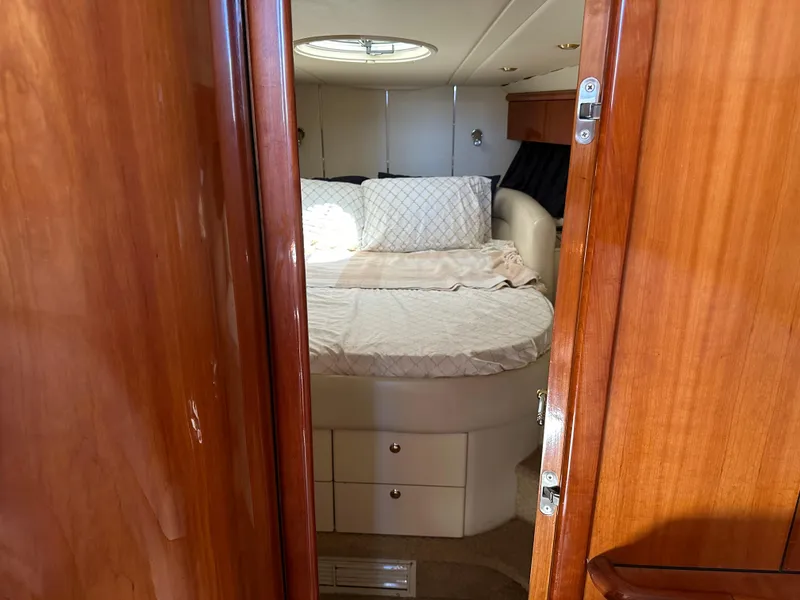 Slide: The Image of Cozy bedroom interior of 1997 Sunseeker Camargue 47 yacht with wooden door and round bed. - 43