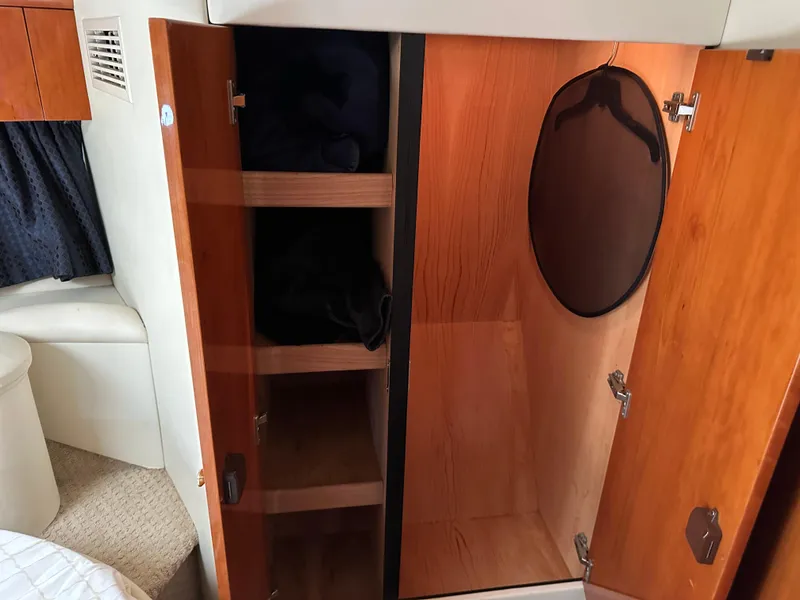 Slide: The Image of Interior of 1997 Sunseeker Camargue 47 showing wooden storage cabinets and closet space. - 49