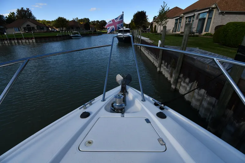 Slide: The Image of Bow view of 1997 Sunseeker Camargue 47 yacht in a canal with a British flag. - 6