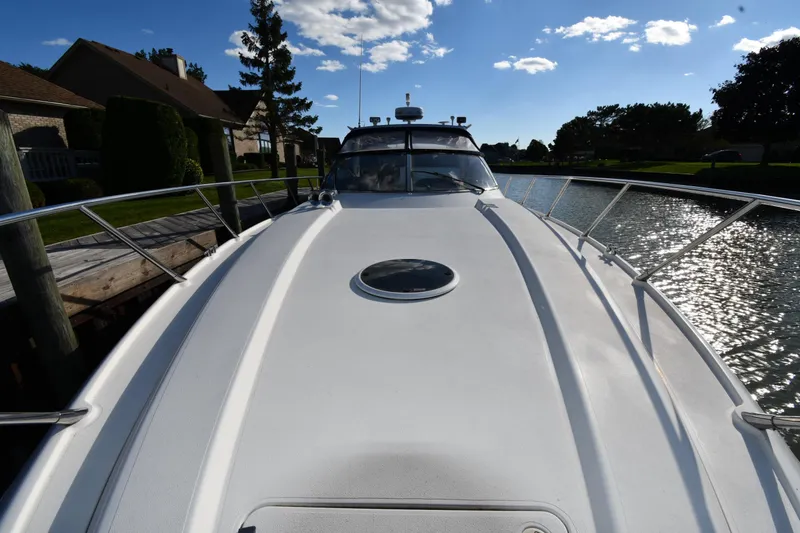 Slide: The Image of 1997 Sunseeker Camargue 47 yacht on a sunny day, docked by a canal. - 7