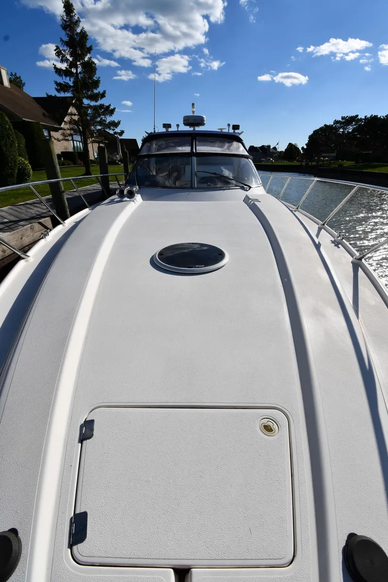 Slide: The Image of 1997 Sunseeker Camargue 47 yacht deck under clear blue sky. - 8
