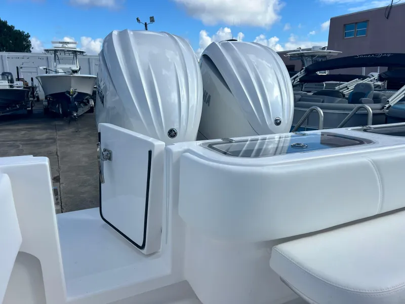 Slide: The Image of Contender 30 ST 2025 boat with dual outboard engines in a marina setting. - 10