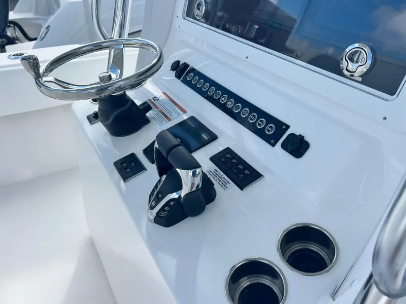 Slide: The Image of 2025 Contender 30 ST boat console with steering wheel and controls. - 11