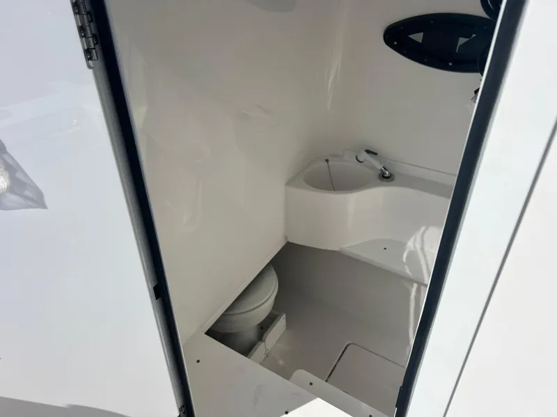 Slide: The Image of 2025 Contender 30 ST boat interior bathroom with toilet and sink. - 17
