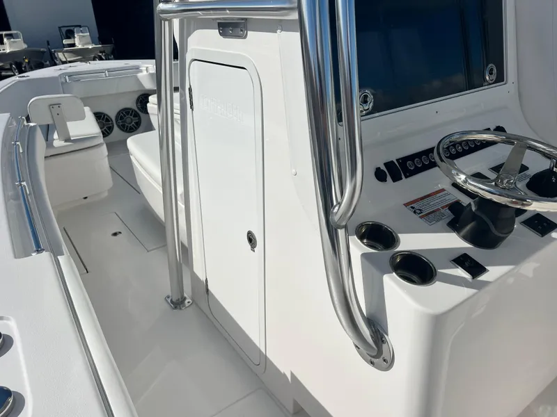 Slide: The Image of 2025 Contender 30 ST boat interior with steering console and seating. - 18