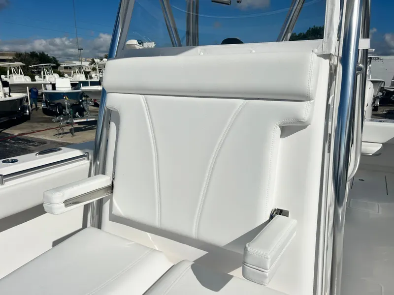Slide: The Image of 2025 Contender 30 ST boat seat with white upholstery and armrests. - 20
