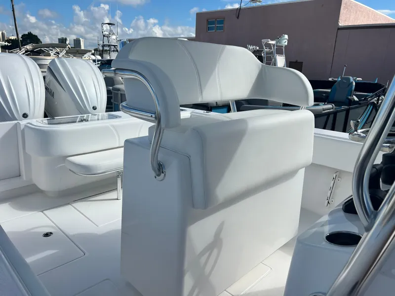 Slide: The Image of 2025 Contender 30 ST boat interior with white seating and dual outboard motors. - 7