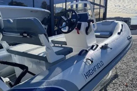 Slide: The Image of 2025 Highfield Classic 380 GT inflatable boat with steering console, docked outdoors. - 3