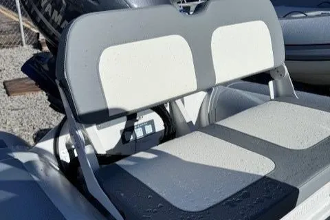 Slide: The Image of Highfield Classic 380 GT 2025 boat interior with cushioned seating and storage compartment. - 7