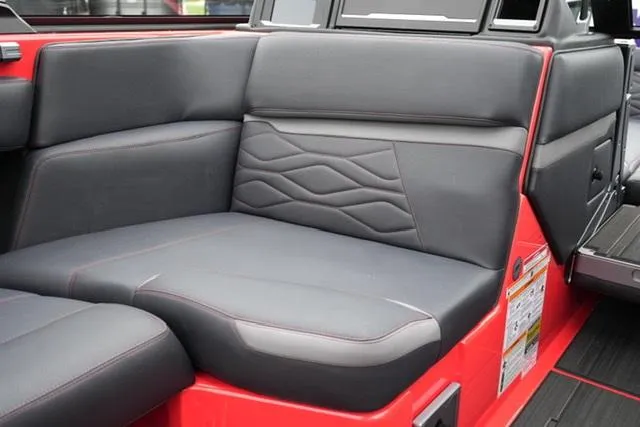 Slide: The Image of 2025 Supra SA 450 boat interior with sleek black and red seating. - 12