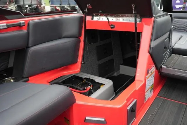 Slide: The Image of 2025 Supra SA 450 boat interior with open storage compartment and seating. - 13