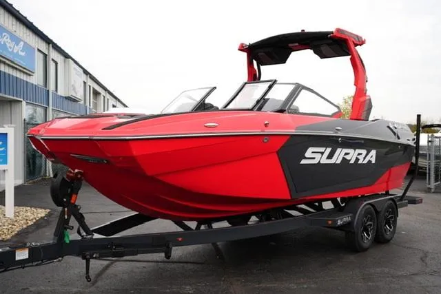 Slide: The Image of 2025 Supra SA 450 boat in vibrant red on a trailer. - 2