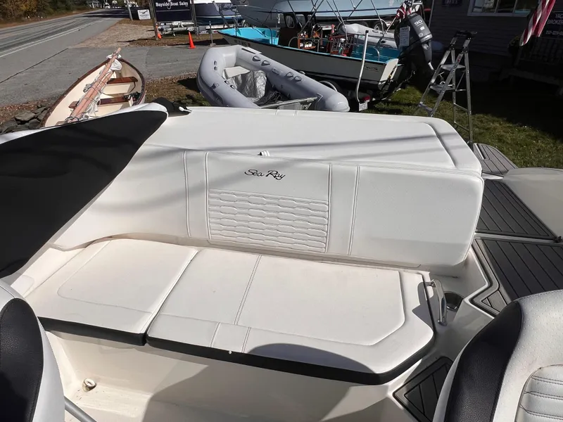 Slide: The Image of 2023 Sea Ray SPX 190 boat interior with white seating and sleek design. - 10
