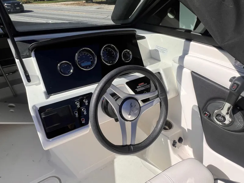 Slide: The Image of 2023 Sea Ray SPX 190 boat dashboard with steering wheel and instrument panel. - 15