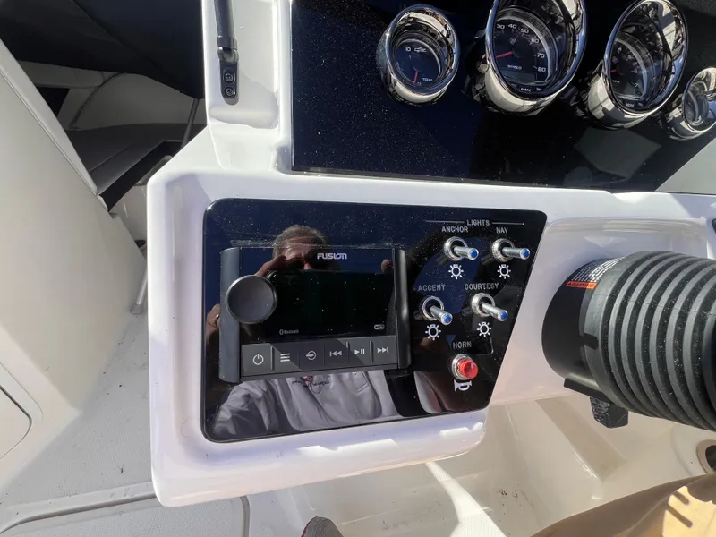 Slide: The Image of 2023 Sea Ray SPX 190 dashboard with controls and gauges. - 18