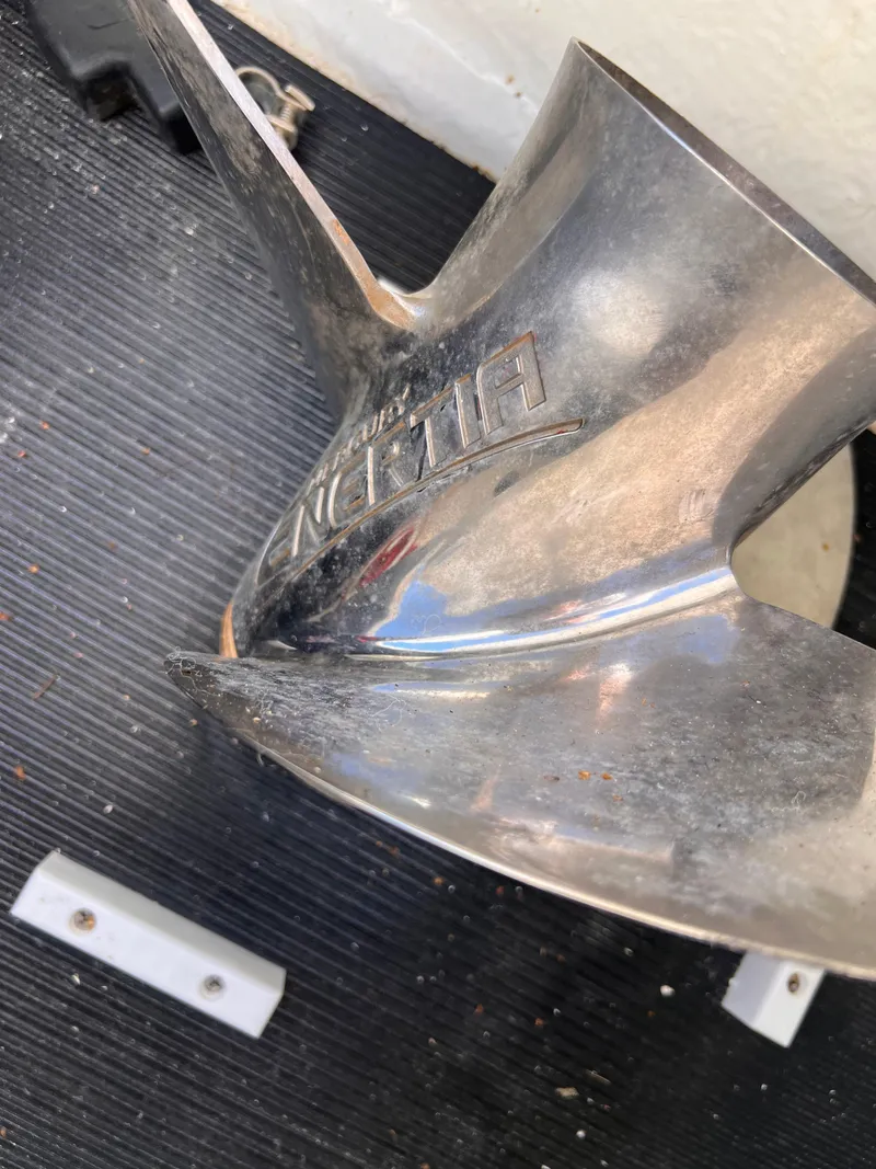 Slide: The Image of Close-up of a 2023 Sea Ray SPX 190 boat propeller on a textured surface. - 25