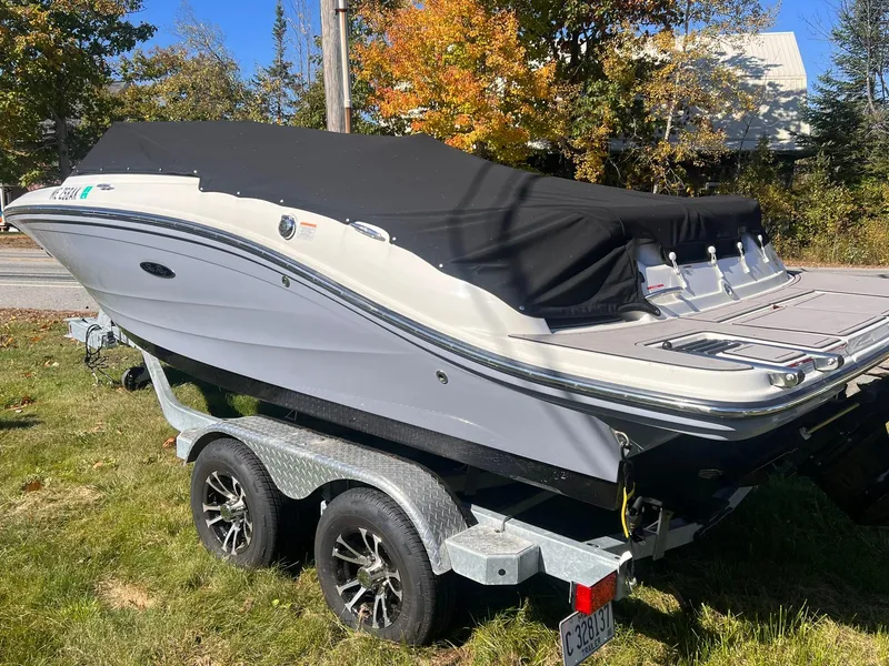Slide: The Image of 2023 Sea Ray SPX 190 boat on trailer, covered, parked on grass. - 3