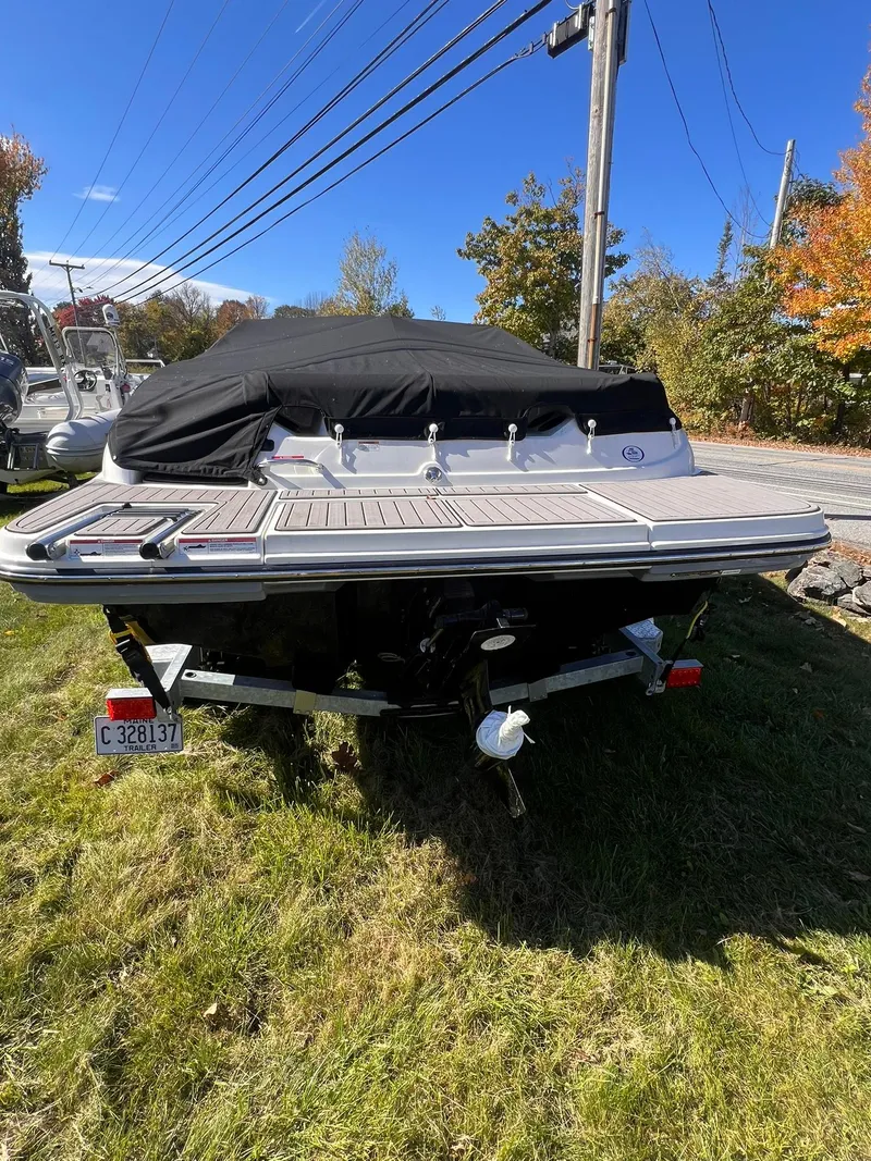 Slide: The Image of 2023 Sea Ray SPX 190 boat on trailer, covered, parked on grass. - 5