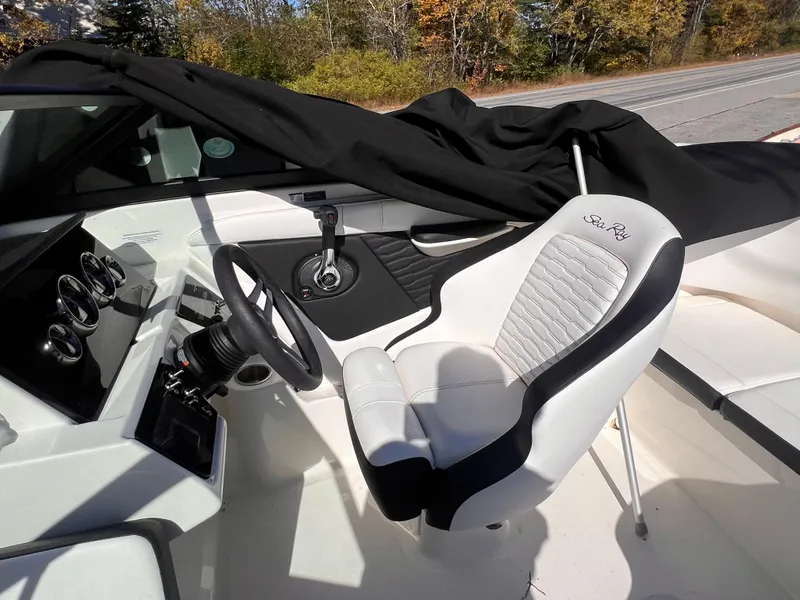 Slide: The Image of 2023 Sea Ray SPX 190 boat interior with steering wheel and captain's chair. - 6