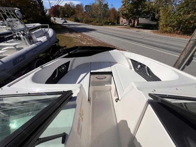 Slide: The Image of 2023 Sea Ray SPX 190 boat interior with white seating and speakers. - 9
