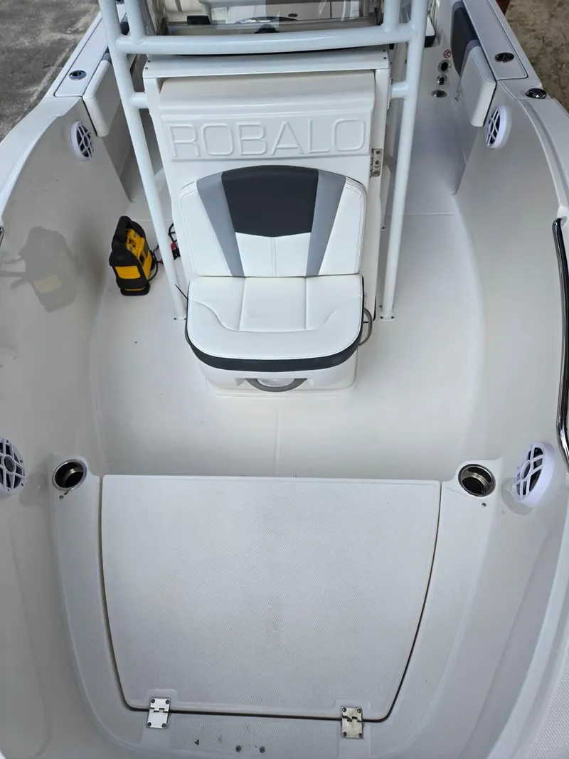 Slide: The Image of 2025 Robalo R180 Center Console boat interior with seating and storage. - 12