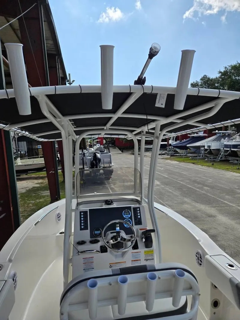 Slide: The Image of 2025 Robalo R180 Center Console boat with T-top and steering console. - 13