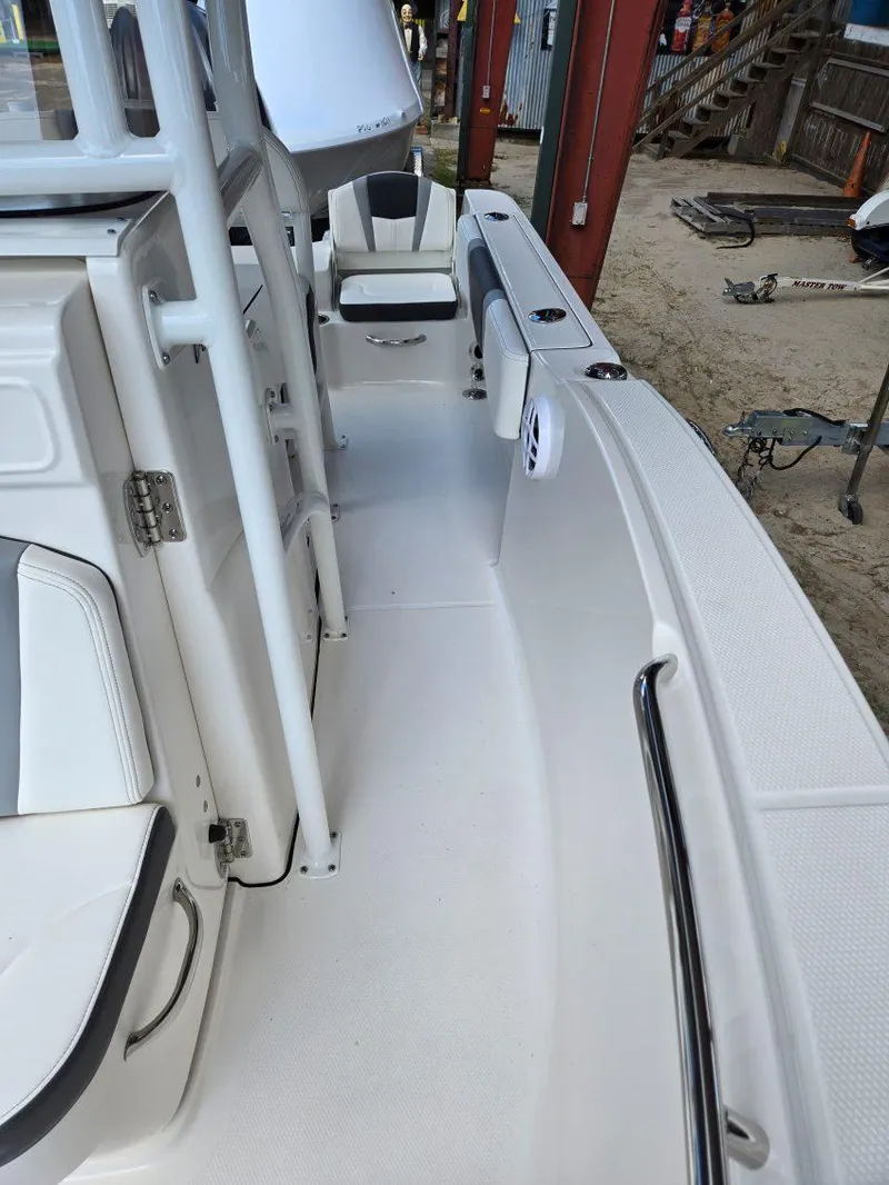 Slide: The Image of 2025 Robalo R180 Center Console boat interior with white seating and storage compartments. - 15