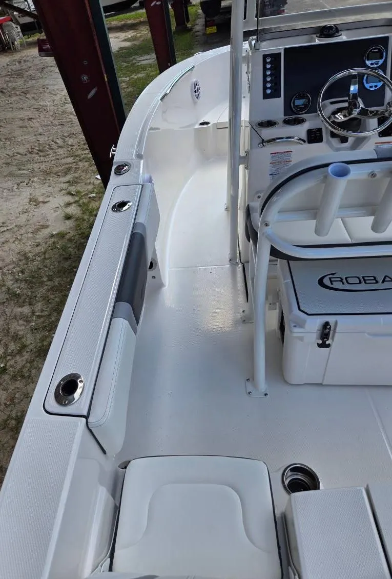 Slide: The Image of 2025 Robalo R180 Center Console boat interior with steering wheel and seating. - 16