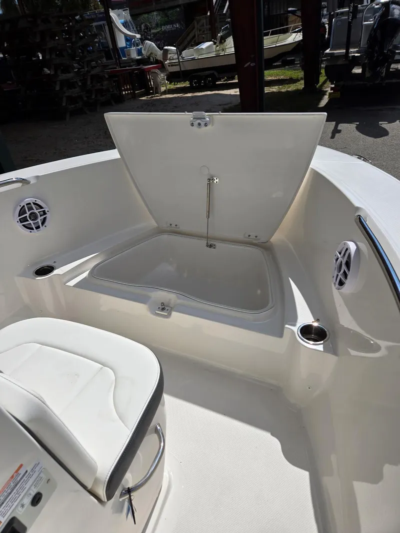 Slide: The Image of 2025 Robalo R180 Center Console boat interior with open storage compartment. - 20