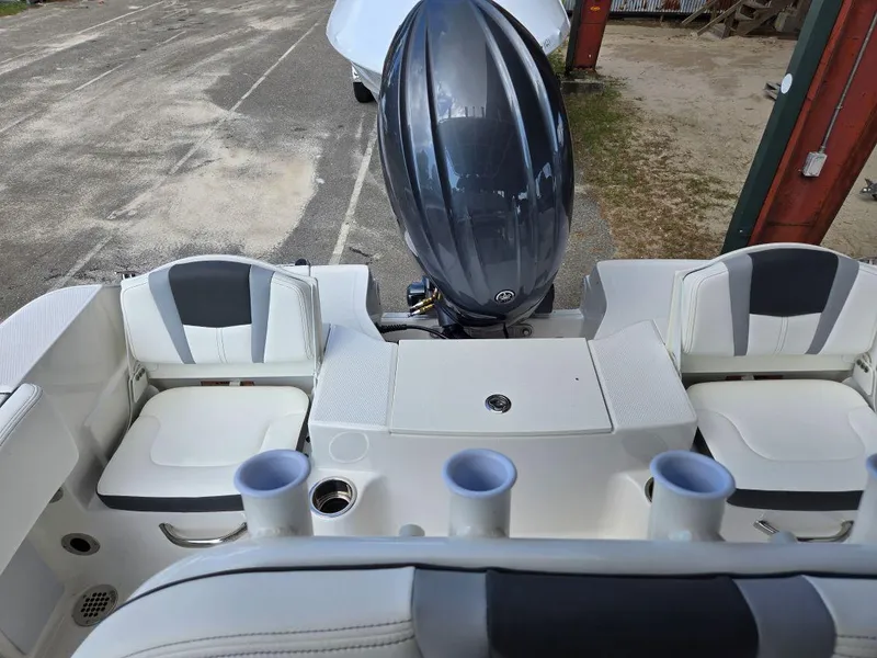 Slide: The Image of 2025 Robalo R180 Center Console boat interior with seating and engine view. - 21