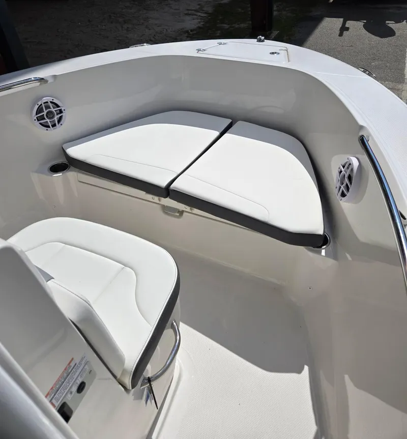 Slide: The Image of 2025 Robalo R180 Center Console boat interior with white seating and modern design. - 4