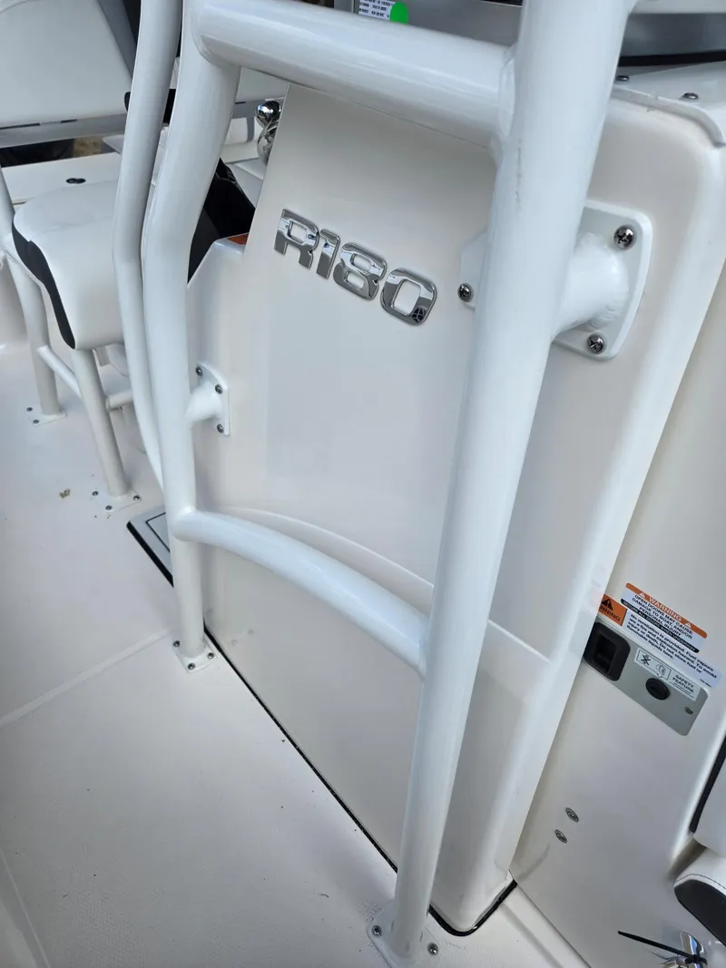 Slide: The Image of 2025 Robalo R180 Center Console boat interior with sleek design and sturdy railing. - 6