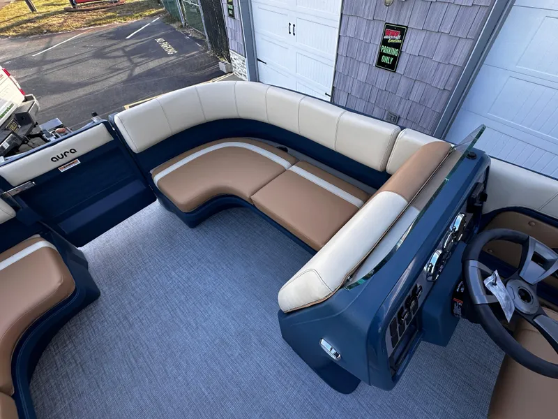 Slide: The Image of 2025 Avalon 2385 Aura Quad Lounge interior with beige and blue seating. - 11