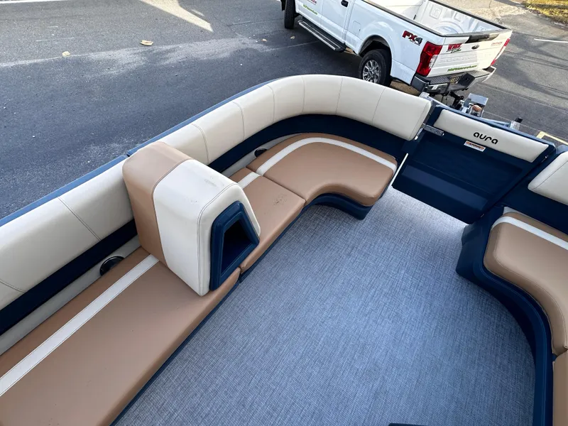 Slide: The Image of Avalon 2385 Aura Quad Lounge 2025 interior with tan and navy seating. - 12