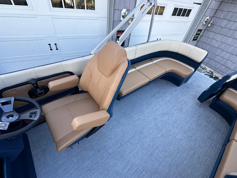 Slide: The Image of 2025 Avalon 2385 Aura Quad Lounge interior with tan seating and modern design. - 14