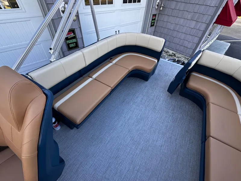 Slide: The Image of 2025 Avalon 2385 Aura Quad Lounge interior with beige and navy seating. - 18