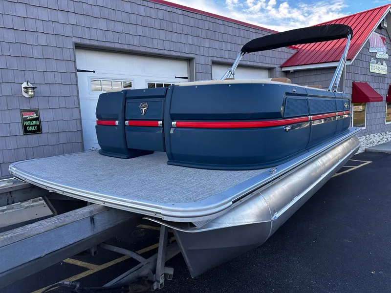 Slide: The Image of 2025 Avalon 2385 Aura Quad Lounge pontoon boat with sleek design and twin toon setup. - 2