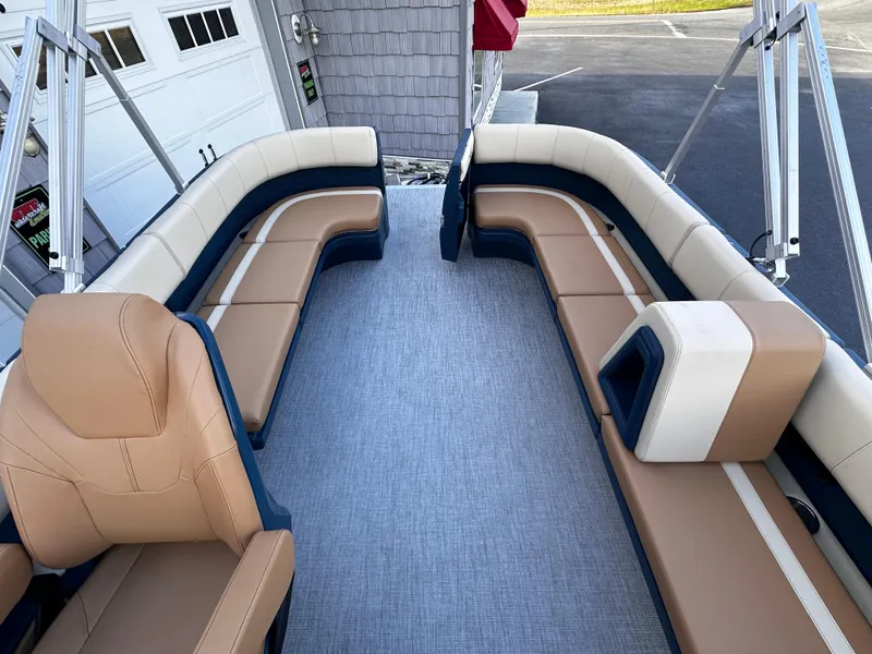 Slide: The Image of 2025 Avalon 2385 Aura Quad Lounge interior with tan and navy seating, spacious layout. - 20