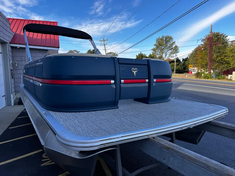 Slide: The Image of 2025 Avalon 2385 Aura Quad Lounge pontoon boat on trailer, parked roadside. - 7