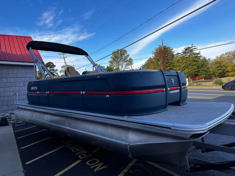 Slide: The Image of 2025 Avalon 2385 Aura Quad Lounge pontoon boat on display outdoors. - 8