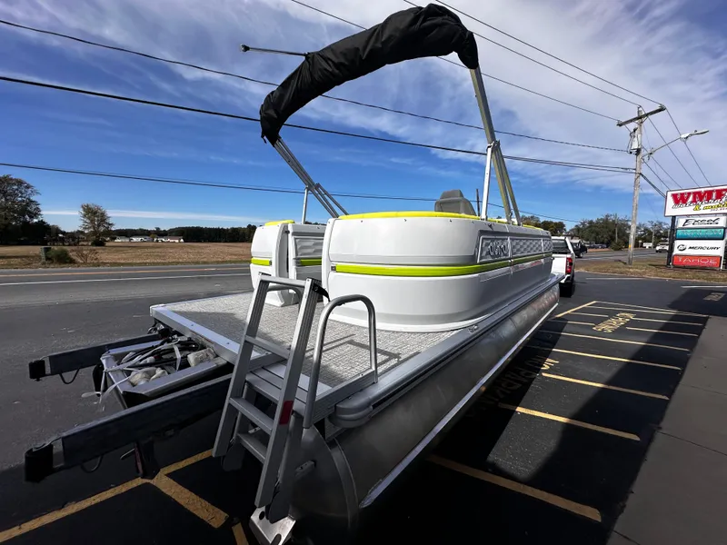 Slide: The Image of 2025 Avalon 2185 Aura Quad Lounge pontoon boat on trailer, parked roadside. - 10