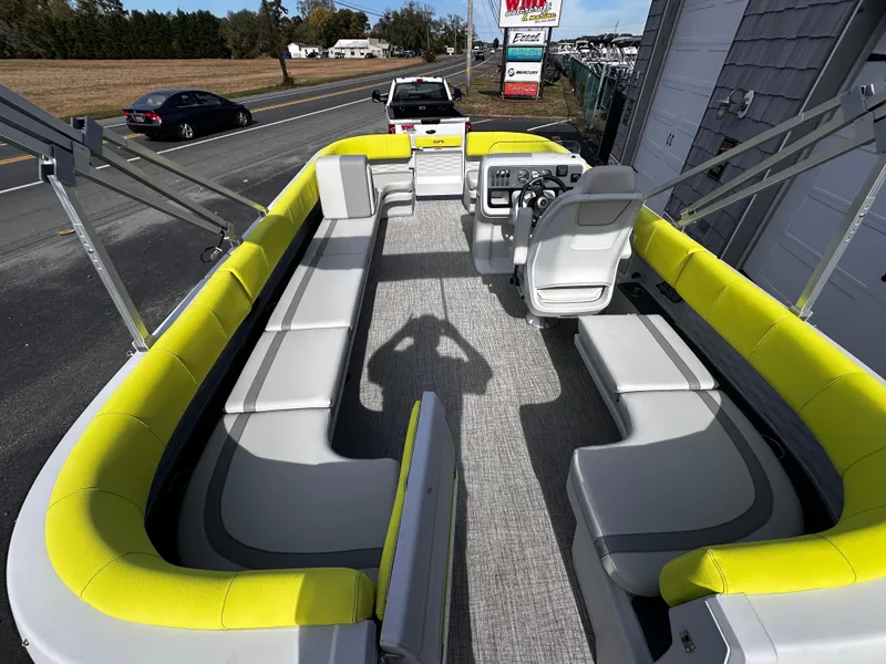 Slide: The Image of 2025 Avalon 2185 Aura Quad Lounge Twin Toon with yellow seating, spacious interior, and modern design. - 13