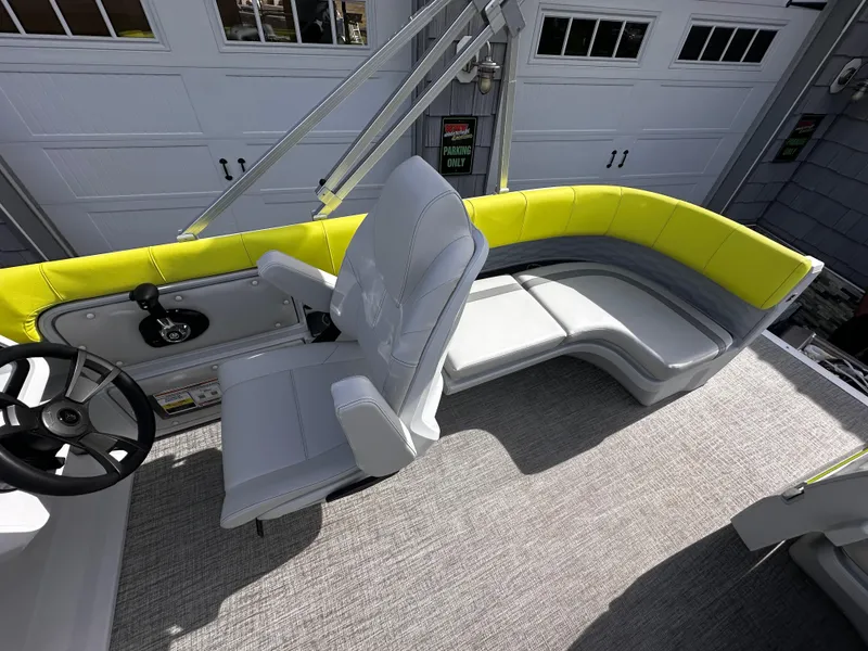 Slide: The Image of 2025 Avalon 2185 Aura Quad Lounge boat interior with gray and yellow seating. - 17