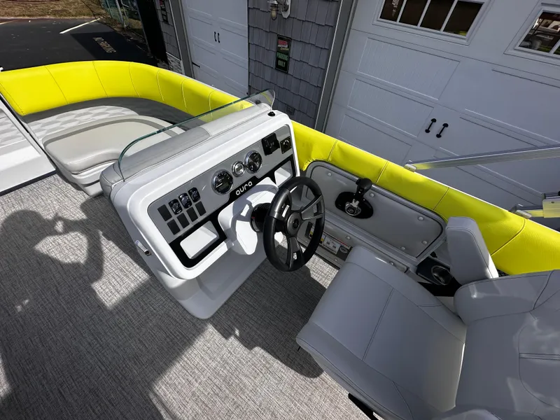 Slide: The Image of 2025 Avalon 2185 Aura Quad Lounge boat interior with modern helm and bright yellow seating. - 18